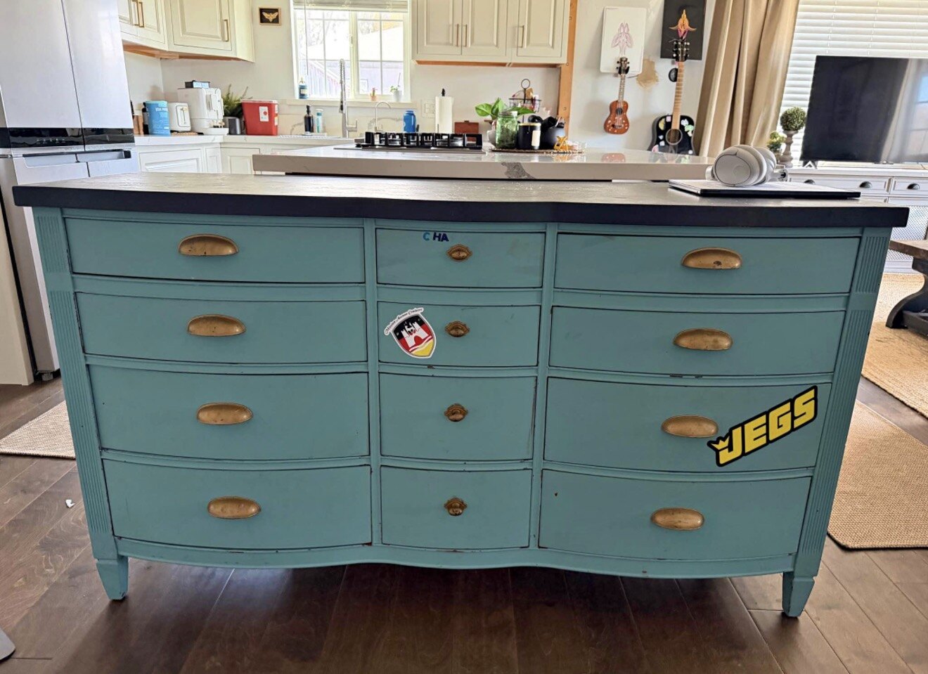 Vanilla Noir dresser before restoration with blue paint and stickers